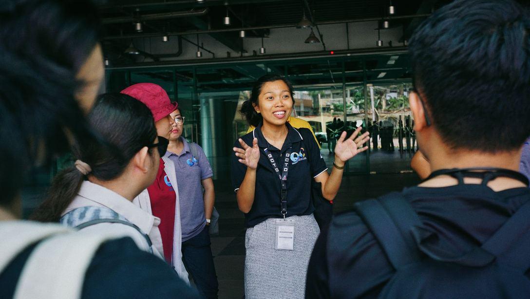 A speaker addressing a group outside a building