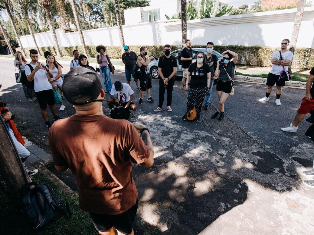 A speaker addressing a group on a city street